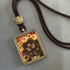 Tibetan Mahakala pendant with an image of the protective deity amulet