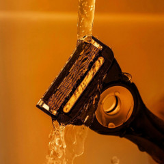 Gillette Labs heated razor with 1 handle, 2 cartridges, and a charging device.