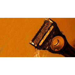 Gillette Labs heated razor with 1 handle, 2 cartridges, and a charging device.