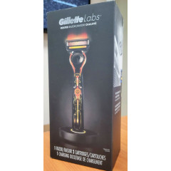 Gillette Labs heated razor with 1 handle, 2 cartridges, and a charging device.