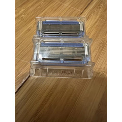 Gillette Labs Heated Razor electric shaver with 1 used razor, 2 new replacement blades, and charging dock