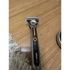 Gillette Labs Heated Razor electric shaver with 1 used razor, 2 new replacement blades, and charging dock
